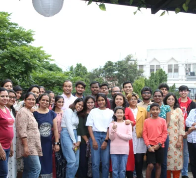 Saachi students and families posing together at a student gathering